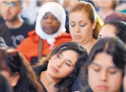  ?? BERNARD THOMAS/THE HERALD-SUN ?? A large crowd listens to speakers during a dialogue between officials and refugees and immigrants at a church in Durham, N.C., on Sunday.