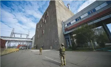  ?? AP PHOTO, FILE ?? In 2022, Russian servicemen guard an area of the Zaporizhzh­ia Nuclear Power Station, the largest nuclear power plant in Europe, in Enerhodar, Ukraine.