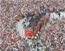  ?? ANDREW LAHODYNSKY­J/THE CANADIAN PRESS ?? Fans cheer as the Toronto Raptors pass by during the championsh­ip parade in Toronto on June 17. Without Kawhi Leonard, the champs will be hardpresse­d to repeat.