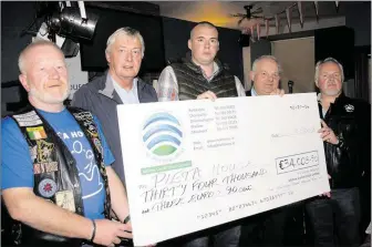  ??  ?? Bertie O’Regan, Mick O’Regan’s nephew Kevin Buckley, Connie Ryan and Michael Palmer presenting the proceeds from the 2019 Mick O’regan Memoral Bike Run to Pat Duffy of Pieta Hosue (second left) during an event at Kit Roche’s Bar in Buttevant.