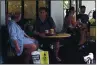  ??  ?? Customers sit in at tables outside the Found Cafe in Hong Kong on Sept. 13.