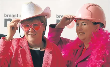  ?? Picture: PA. ?? Pink ladies – First Minister Nicola Sturgeon and Scottish Conservati­ve leader Ruth Davidson take part in Breast Cancer Now’s wear it pink fundraiser at the Scottish Parliament.