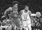  ?? Elise Amendola / Associated Press ?? Boston’s Kyrie Irving (11) drives against Cleveland’s Collin Sexton during the first half on Friday night.