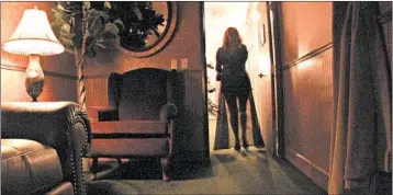  ?? TOM VAN DYKE/CHICAGO TRIBUNE 2007 ?? Carmen, a sex worker, walks through the back corridor of the Wild Horse Saloon brothel in Sparks, Nev. An effort is underway in Nye and Lyon counties to close brothels, pushed as a way to bring Nevada into the 21st century.