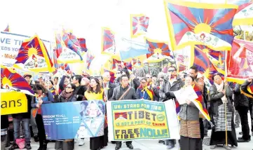  ?? — Reuters photo ?? People take part in a demonstrat­ion against China during its Universal Periodic Review by the Human Rights Council in front of the United Nations Office in Geneva, Switzerlan­d.