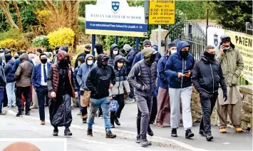  ??  ?? Anger: Protesters outside the gates of Batley Grammar