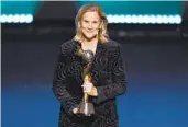  ?? ALAN LEE AP ?? Former U.S. women coach Jill Ellis, now president of the San Diego Wave, poses with WC trophy Saturday.