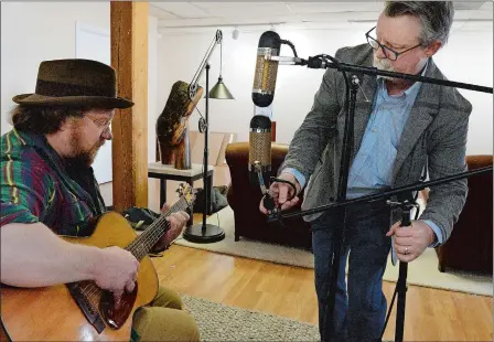  ?? DANA JENSEN/THE DAY ?? David Cope, right, proprietor of Old Forge Studio in Mystic, adjusts the ribbon microphone­s while preparing to record a song by Craig Edwards of Mystic in the studio on Friday.