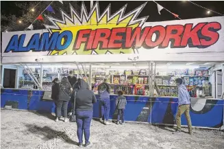  ?? Tom Reel/Staff photograph­er ?? Customers shop at an Alamo Fireworks stand in December 2020. The products sold have largely kept the stores from being overwhelme­d by online and big box retailers like Amazon and Walmart.