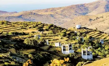  ?? ?? A profusion of dovecotes built like carved towers dot the countrysid­e among stonewalle­d terraces on the island of Tinos, known for its marble quarries and resulting marble crafts.