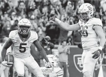  ?? Richard W. Rodriguez / Associated Press ?? Baylor receiver Denzel Mims, left, and tight end Ben Sims celebrate a third-quarter touchdown against Texas on Saturday.