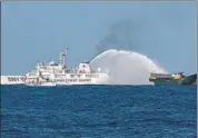 ?? REUTERS ?? Chinese Coast Guard vessels fire water cannons towards a Philippine vessel on its way to a resupply mission at Second Thomas Shoal in the South China Sea, on March 5.