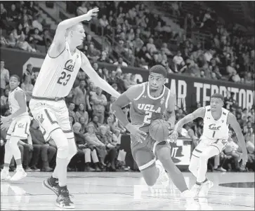  ?? Ben Margot Associated Press ?? UCLA’S CODY RILEY drives against California’s Connor Vanover as Darius McNeill (1) trails the play.