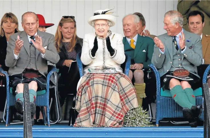 ??  ?? FUN AND GAMES: The duke, the Queen and Prince Charles enjoying the action at the Braemar Gathering in 2014 and, below right, the duke and the Queen at the Braemar Gathering in 2016.