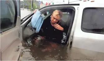  ?? LM OTERO, AP ?? Rhonda Worthingto­n’s vehicle is one of as many as 1 million in Texas damaged or destroyed by floods caused by Hurricane Harvey.