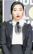  ?? Valerie Macon / AFP via Getty Images ?? Awkwafina in an elegant Dior tuxedo gown