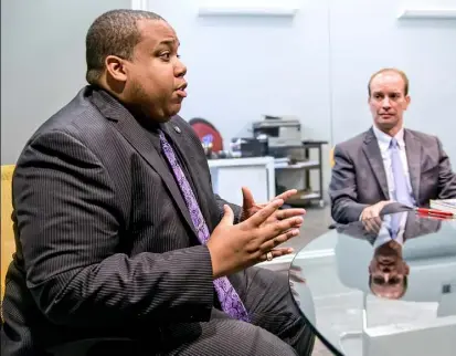  ?? Allison Farrand/Post-Gazette ?? David King, left, and his attorney Matthew Heron at the Debt Doctors office on Penn Avenue.