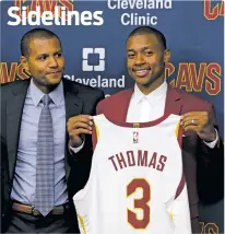  ??  ?? The Cavaliers’ Isaiah Thomas, right, deferred questions about his injured hip to general manager Koby Altman, who quickly grew tired of questions about Thomas’ health during a news conference Thursday in Cleveland.