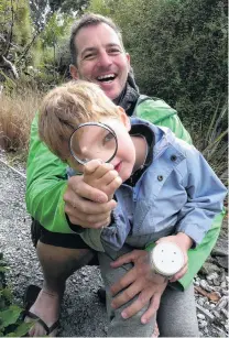  ?? PHOTO: RICHARD DAVISON ?? I spy . . . Jake (5) and father Gareth Hallam, of Christchur­ch, hunt for bugs during the South Otago Kiwi Conservati­on Club family day at Earthlore, Owaka, yesterday.