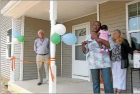  ?? DIGITAL FIRST MEDIA FILE PHOTO ?? Patricia Nnah, holding her 10-week-old daughter, Lukeni, thanks everyone who helped with her new home in North Hills. With her are Gary Lasher, vice president of the board, and Jean Ford, director of family services, Habitat for Humanity of Montgomery...