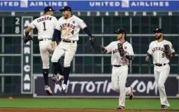  ?? Associated Press ?? Houston Astros' Carlos Correa (1), George Springer (4), Josh Reddick (22) and Marwin Gonzalez (9) celebrate their win over the Boston Red Sox in Game 1 of baseball's American League Division Series on Thursday in Houston.