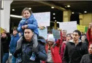  ?? RICK KAUFFMAN – DIGITAL FIRST MEDIA ?? Mohamed Bakry, left, who immigrated from Egypt in 1985 and became an American citizen in 1998, carries 4-year-old daughter Mariam Bakry, in a protest on ban of immigrants from seven predominan­tly Muslim nations last weekend at Philadelph­ia...