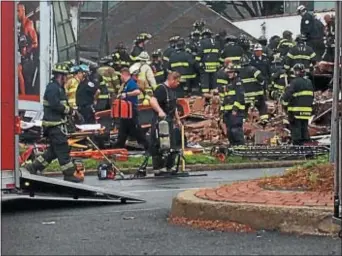  ?? L.A. PARKER - THE TRENTONIAN ?? Emergency crews respond to a collapsed building that was occupied.