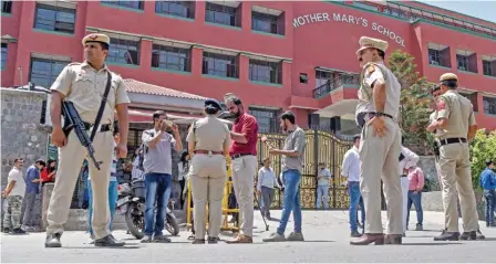  ?? (ANI) ?? Delhi Police stand guard outside the Mother Mary School after a bomb threat to several schools in Delhi-ncr, at Mayur Vihar Please 1 in New Delhi on Wednesday