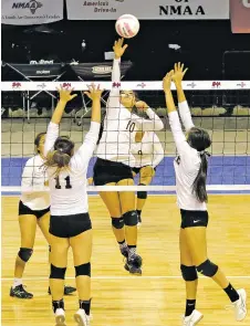  ?? JANE PHILLIPS/FOR THE NEW MEXICAN ?? Santa Fe Indian School’s Leanna Lewis, center, returns a volley to Cobre’s Amaya Jacquez, front, and Hayleigh Salgado on Thursday during a Class 4A State Volleyball Tournament first-round match against Cobre at the Santa Ana Star Center. The Lady...