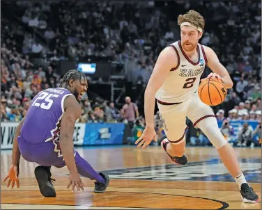  ?? Associated Press ?? Driving: Gonzaga forward Drew Timme, right, drives the lane past TCU center Souleymane Doumbia in the second half of a second-round college basketball game in the men's NCAA Tournament Sunday in Denver.