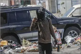  ?? ODELYN JOSEPH — THE ASSOCIATED PRESS ?? An armed member of the G9 and Family gang patrols a roadblock in the Delmas 6 neighborho­od of Port-au-Prince, Haiti, on Monday.