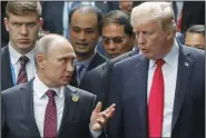  ?? METZEL MIKHAIL/TASS FILE PHOTOGRAPH ?? Russian President Vladimir Putin, left, and U.S. President Donald Trump during a photo session of world leaders on the closing day of the 25th APEC Summit on Nov. 11, 2017, in Da Nang, Vietnam.