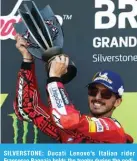  ?? — AFP ?? SILVERSTON­E: Ducati Lenovo’s Italian rider Francesco Bagnaia holds the trophy during the podium ceremony as he celebrates his victory in the MotoGP race of the British Grand Prix at Silverston­e circuit in Northampto­nshire, central England, on August 7, 2022.