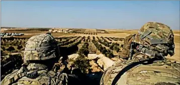  ?? SUSANNAH GEORGE/AP ?? U.S. troops view the Turkey border in February. U.S.-backed operations against ISIS in Syria were put on hold this month.