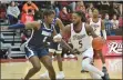  ?? KYLE FRANKO/ TRENTONIAN PHOTO ?? Rider’s Mervin James, right, drives to the basket on Monmouth’s Myles Foster, left, on Wednesday night at Alumni Gymnasium in Lawrencevi­lle.