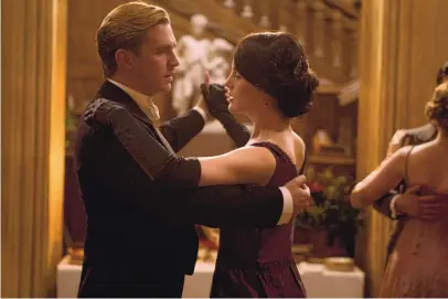  ?? COURTESY OF MASTERPIEC­E ?? Dan Stevens as Matthew Crawley and Michelle Dockery as Lady Mary a dance scene from “Downton Abbey,” which will see another movie released in 2022.