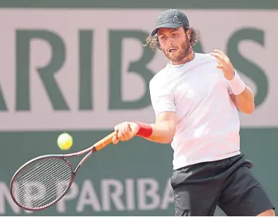  ?? Getty. ?? Novak Djokovic, top left, in action during his first round victory over Brazilian Rogerio Dutra Silva; Rafael Nadal, top right, was left frustrated as bad weather halted his match with Simone Bolelli; lucky loser Marco Trungellit­i, above, during his...