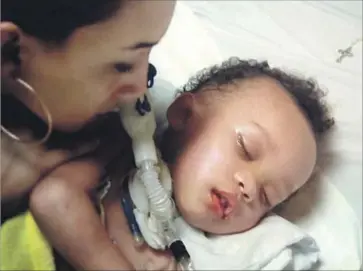  ??  ?? JONEE FONSECA looks at her son Israel Stinson on life support. In April, he had a severe asthma attack and a heart attack that left him in a coma. Doctors at a Sacramento hospital later declared him brain-dead.