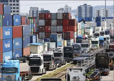  ?? (AP/Yonhap/Hong Ki-won) ?? Trucks are parked Monday next to containers at the Inland Container Depot in Uiwang, South Korea. A weeklong strike by thousands of truckers in South Korea has disrupted cargo transport and production that have caused $1.2 billion in damages, officials said.