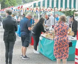  ?? Picture: Dougie Nicolson. ?? People browsing some of the market stalls at South Inch on Saturday.