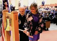  ?? Jerry Lara/Staff photograph­er ?? Master Sgt. Terry Smith and wife Felicity ring a bell Tuesday to honor San Antonio’s top recruiters.