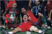  ??  ?? Portugal celebrate their Euro 2016 victory against France.