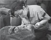  ?? PHOT0S PROVIDED TO CHINA DAILY ?? Top: A Terracotta Warrior depicting a Qin Dynasty general adorns researcher Xu Weihong’s recently published book, Archaeolog­ical Gleanings — Back to the Qin Dynasty. Middle: Xu cleans bricks found in the ancient Xianyang city site in Shaanxi province. Above: Xu helps restore a Terracotta Warrior.