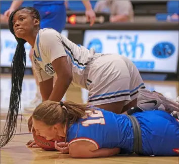  ?? Steve Mellon/Post-Gazette ?? Woodland Hills’ Hope Hawkins, top, comes up after a scramble for the ball with Armstrong’s Kyla Fitzgerald Thursday night in a WPIAL Class 5A game won by Woodland Hills, 61-51.