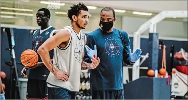  ?? PHOTO COURTESY OF UCONN ATHLETICS ?? UConn guard James Bouknight takes instructio­n from assistant coach Kimani Young during the Huskies’ first practice on Friday on Storrs.