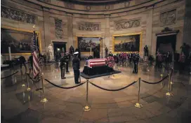  ?? [PHOTO BY MEGAN ROSS, GAYLORD NEWS] ?? The body of former President George H.W. Bush lies in state in the U.S. Capitol rotunda on Monday.