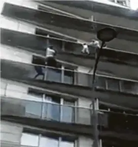  ?? / Associated Press ?? Mamoudou Gassama, a Mali migrant who arrived in Paris in September without documentat­ion, scales an apartment building to save a dangling child.
