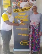  ?? ?? Calisile Mtsetfwa from Buhleni accepting her grocery voucher from MTN Eswatini.