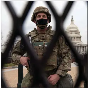  ?? (AP/Jose Luis Magana) ?? This National Guardsman is among thousands standing watch Friday at the U.S. Capitol, where security has ramped up since a mob stormed the Capitol last week and ahead of Joe Biden’s inaugurati­on Wednesday. More photos at arkansason­line.com/116dcguard/.