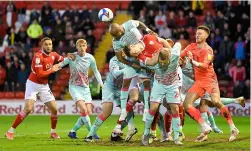  ??  ?? Andre Ayew heads a Barnsley corner clear in the second half.